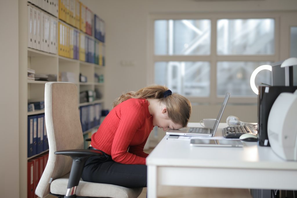 woman in red long sleeve shirt sitting on chair while 3791134 scaled