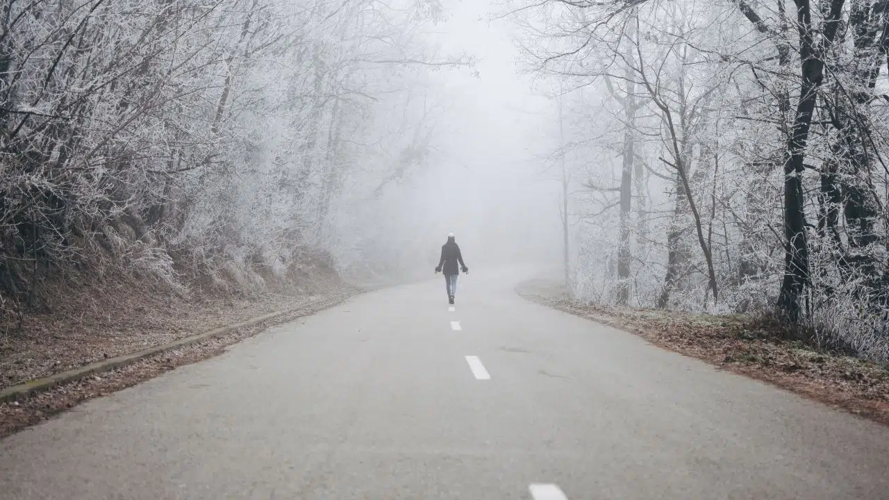 Walking alone under the harsh sun